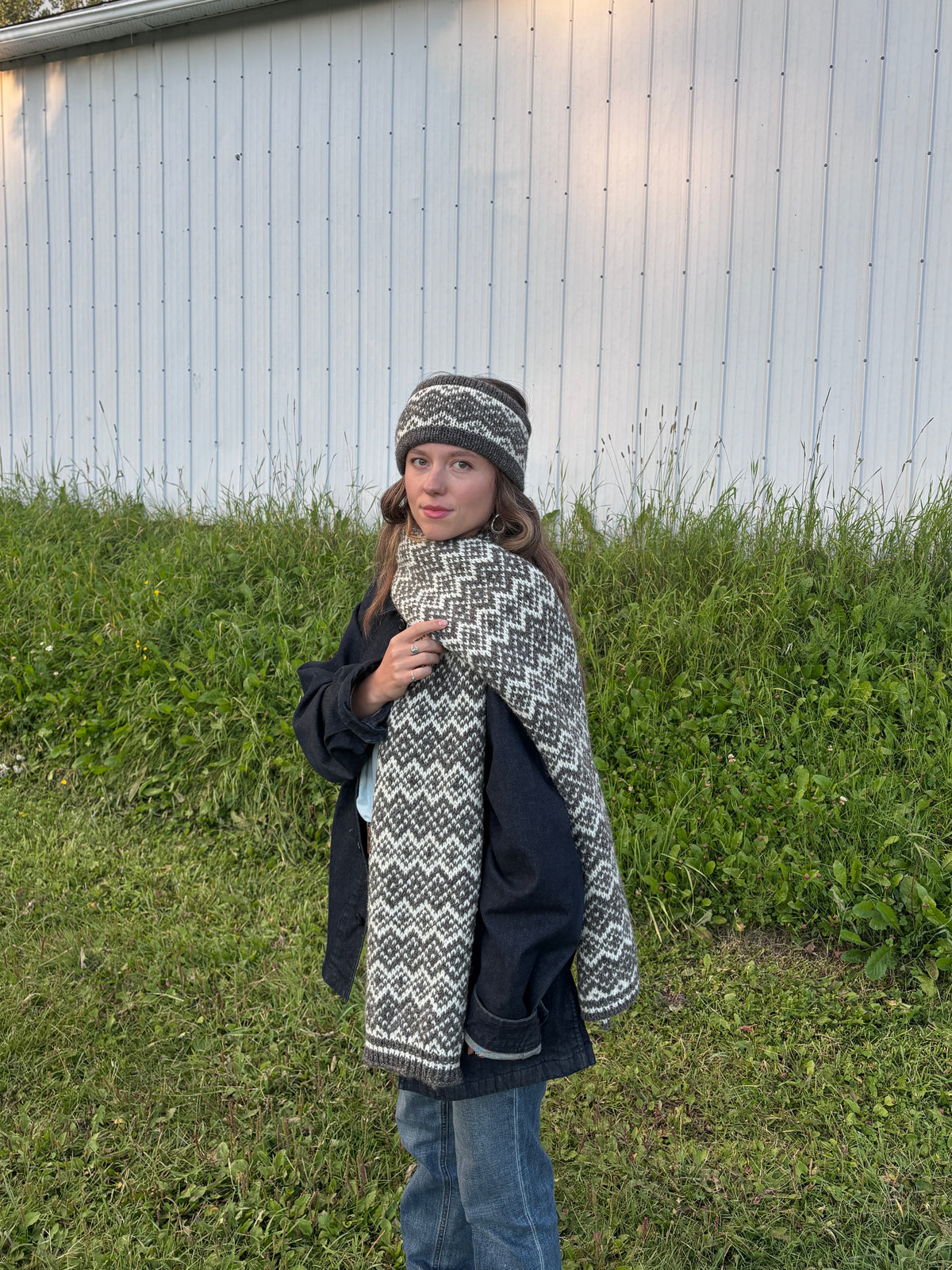 Woman wearing geometric colourwork wool headband and scarf