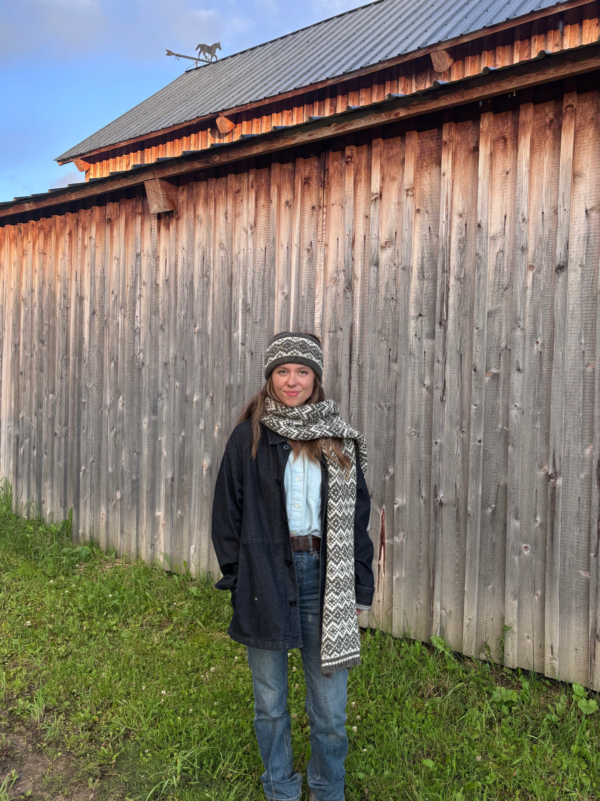 Woman wearing geometric colourwork wool headband and scarf